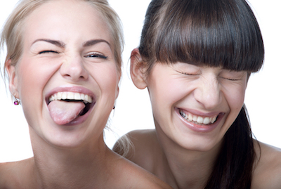 two girls laughing with fresh faces