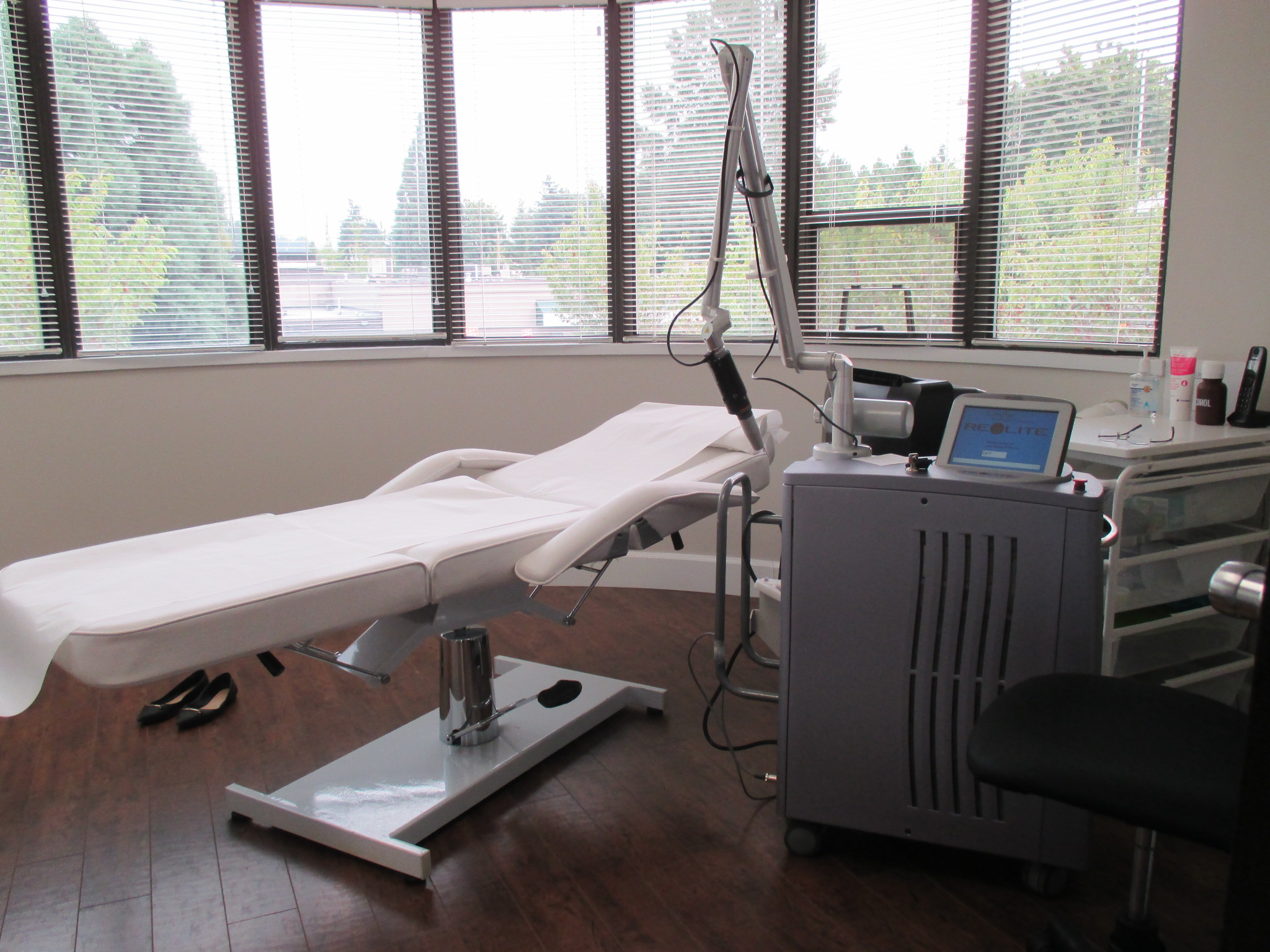 a treatment room with laser and bed