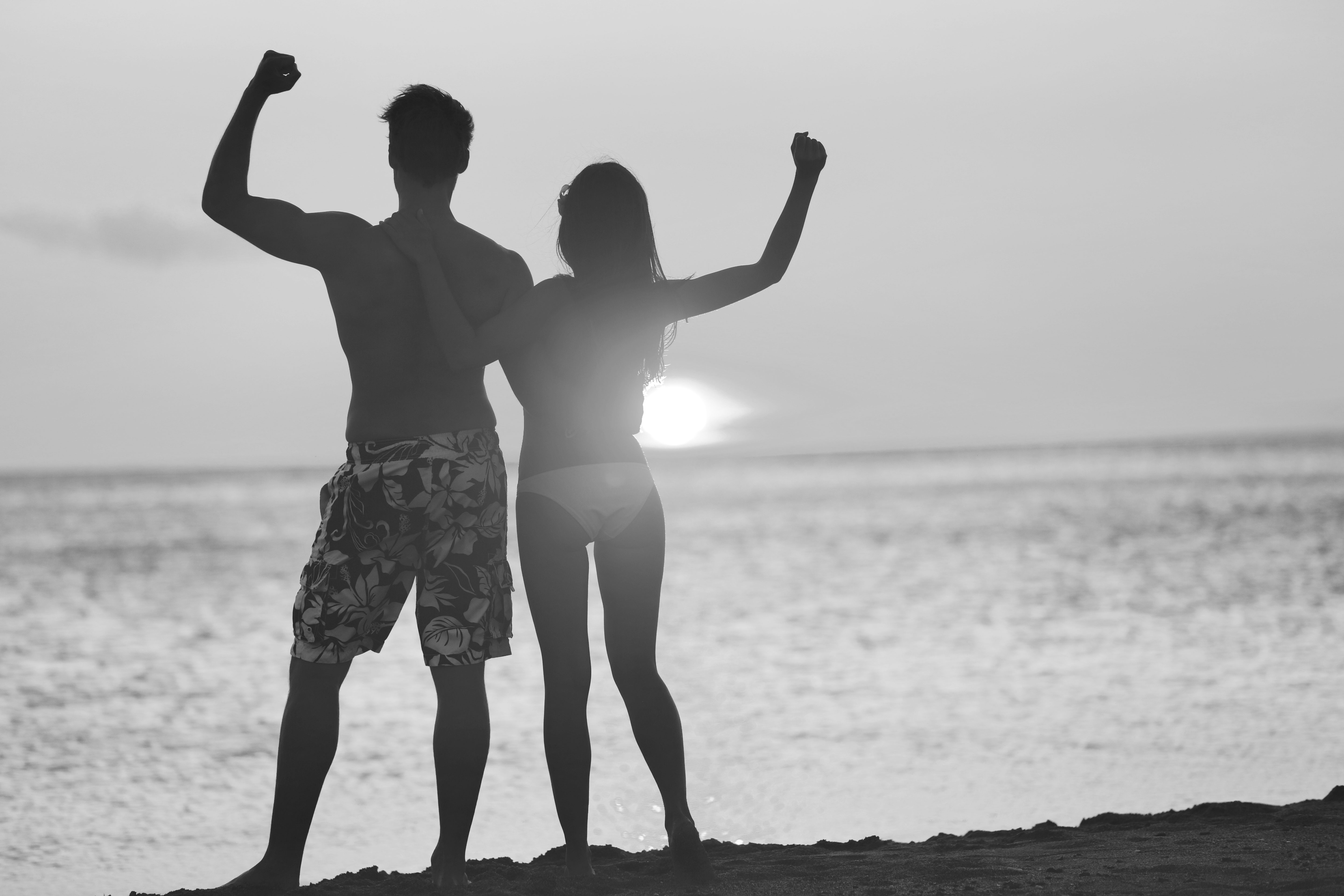 couple standing in the sunset on a beach